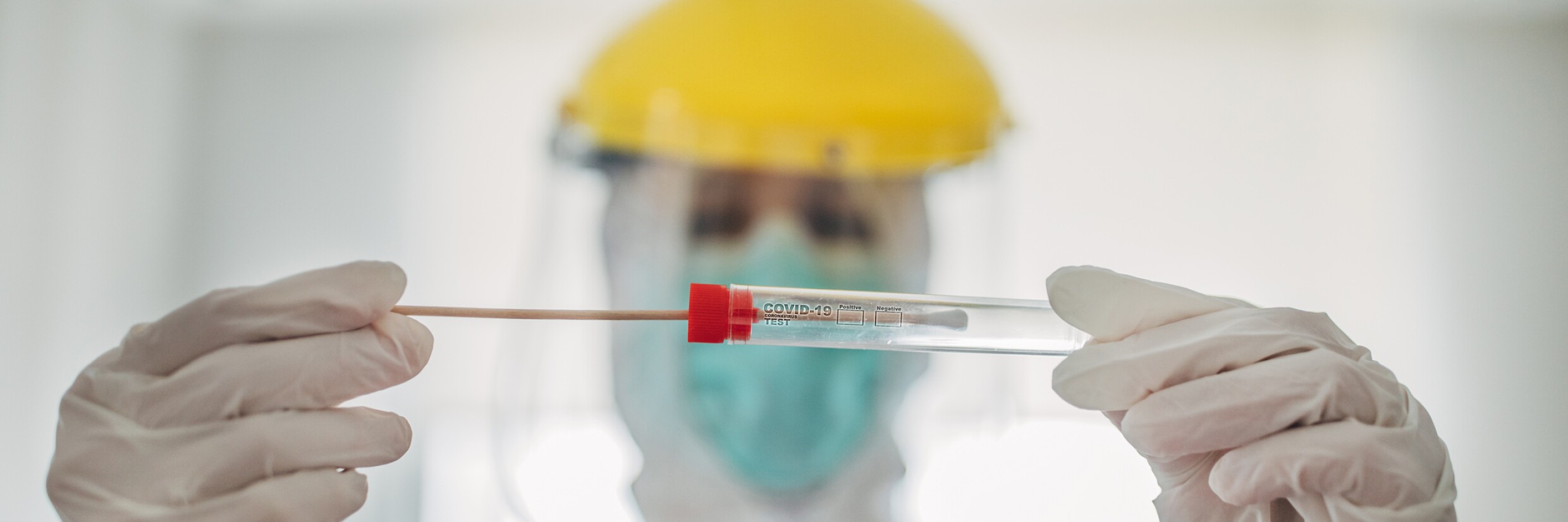 Doctor showing covid-19 tube test and sampling swab